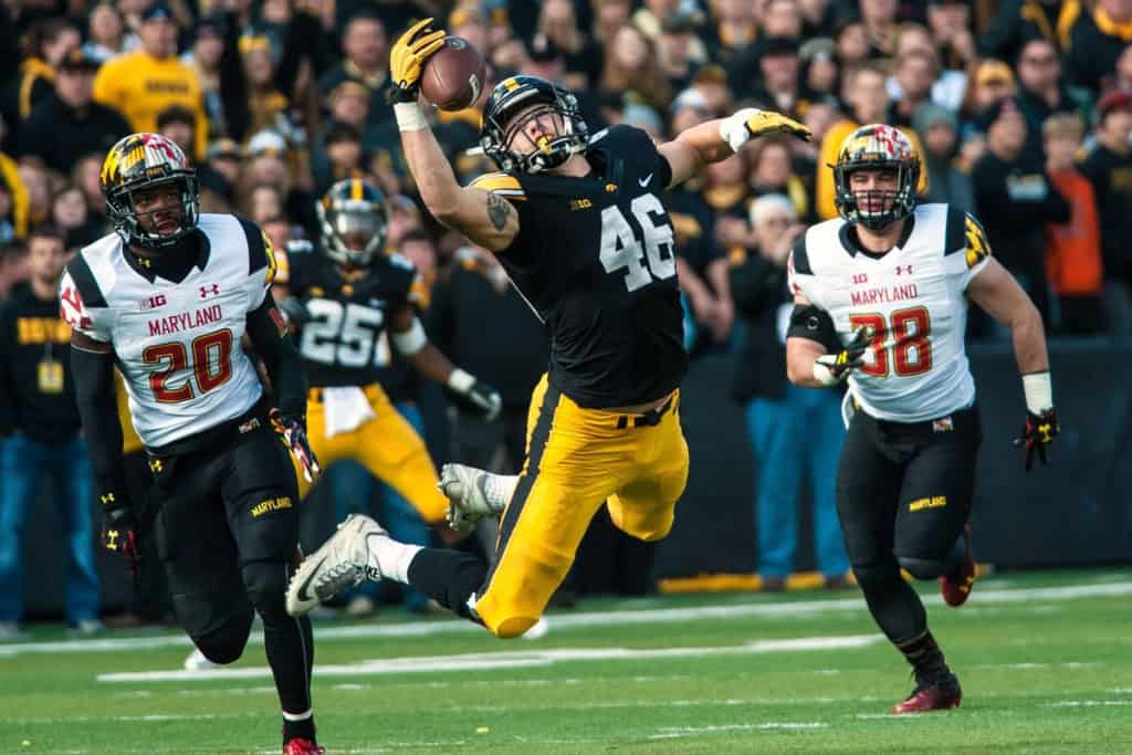 Iowa Hawkeyes tight end makes a leaping one-handed catch against Maryland, showing university draft picks that earned First Team All-Pro honors.