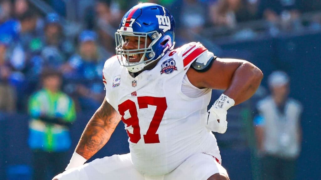Dexter Lawrence lines up on defense in a white New York Giants uniform before the snap against Washington.