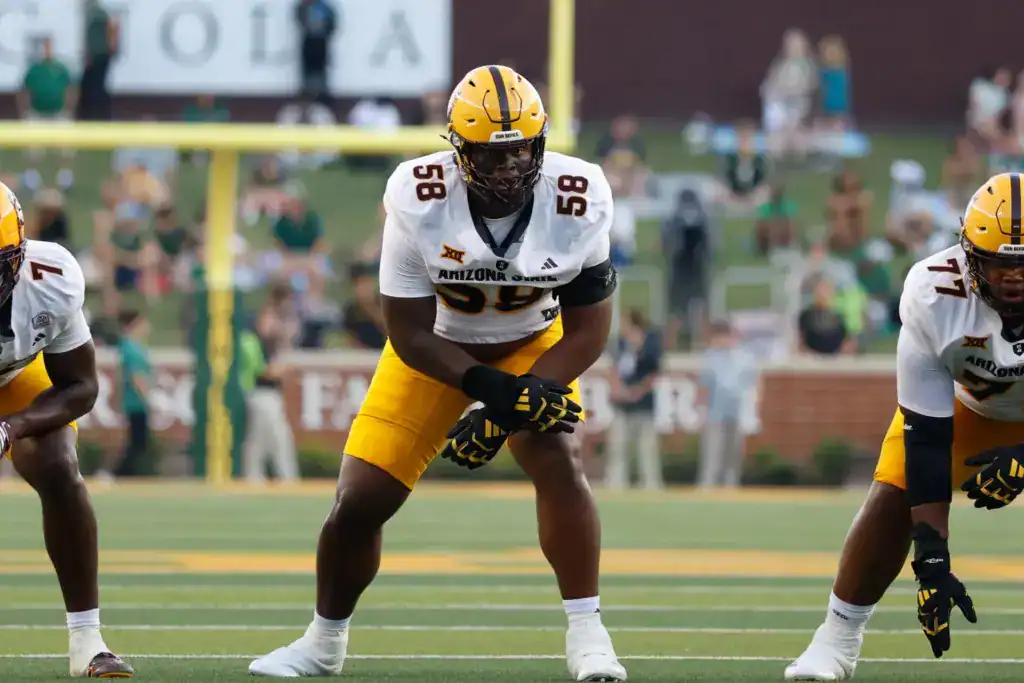 Max Iheanachor, Arizona State draft prospect, lined up pre-snap in a white Sun Devils uniform during a game.