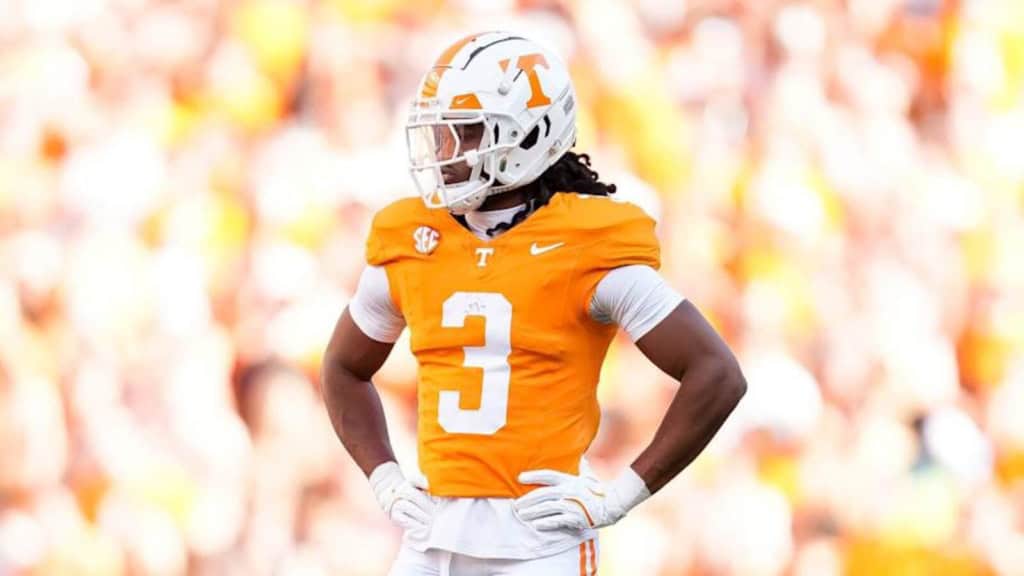Tennessee cornerback Jermod McCoy stands with his hands on his hips in an orange Volunteers uniform during a game, highlighting one of the top 2026 NFL Draft prospects.