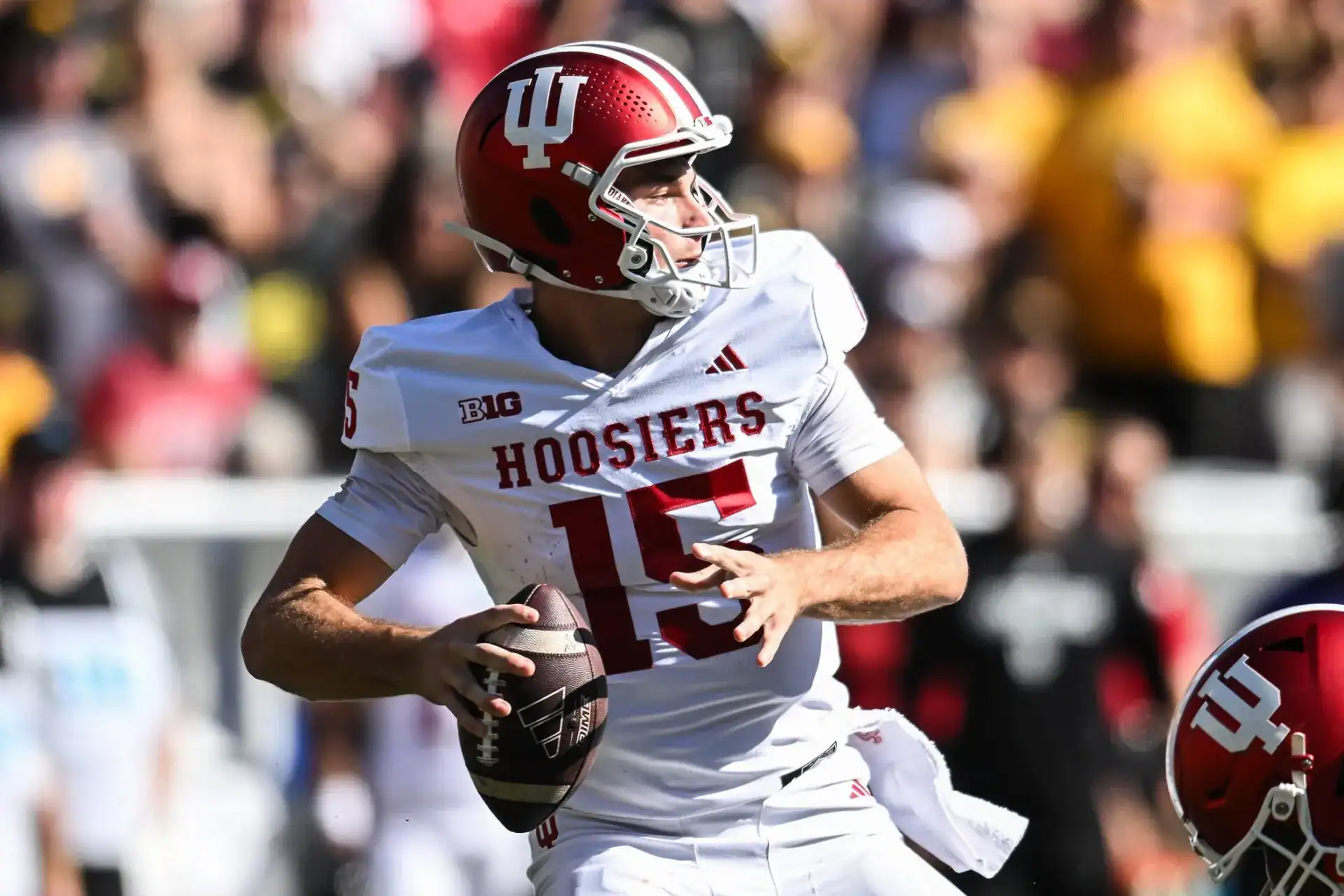 Indiana quarterback Fernando Mendoza drops back to pass during a game, showing the arm talent that has him drawing NFL Draft attention.