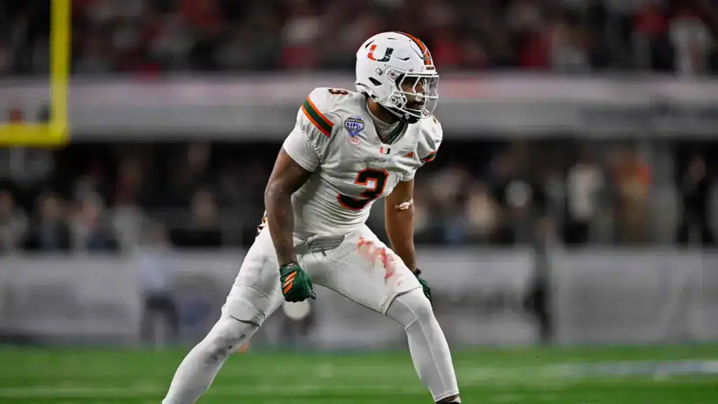 Akheem Mesidor's 2026 Draft Red Flag For Teams Like the Cowboys 2026 NFL Draft prospect Akheem Mesidor lines up in a white Miami Hurricanes uniform before the snap during game action.