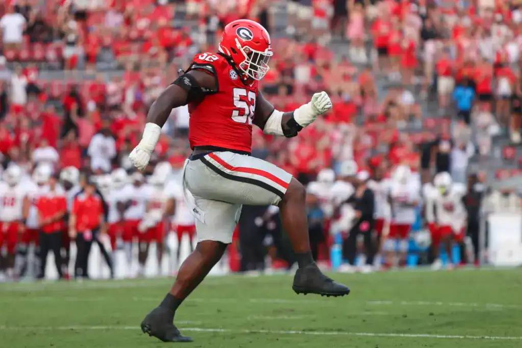 Christen Miller, Georgia draft prospect, celebrating on the field in a red Bulldogs uniform during a game.