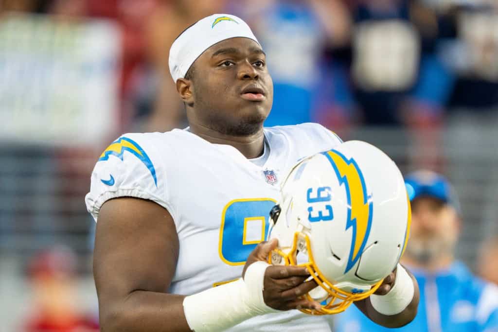 Otito Ogbonnia shown in a Los Angeles Chargers uniform as a defensive line option in the Dallas Cowboys 2026 defensive depth chart projection.