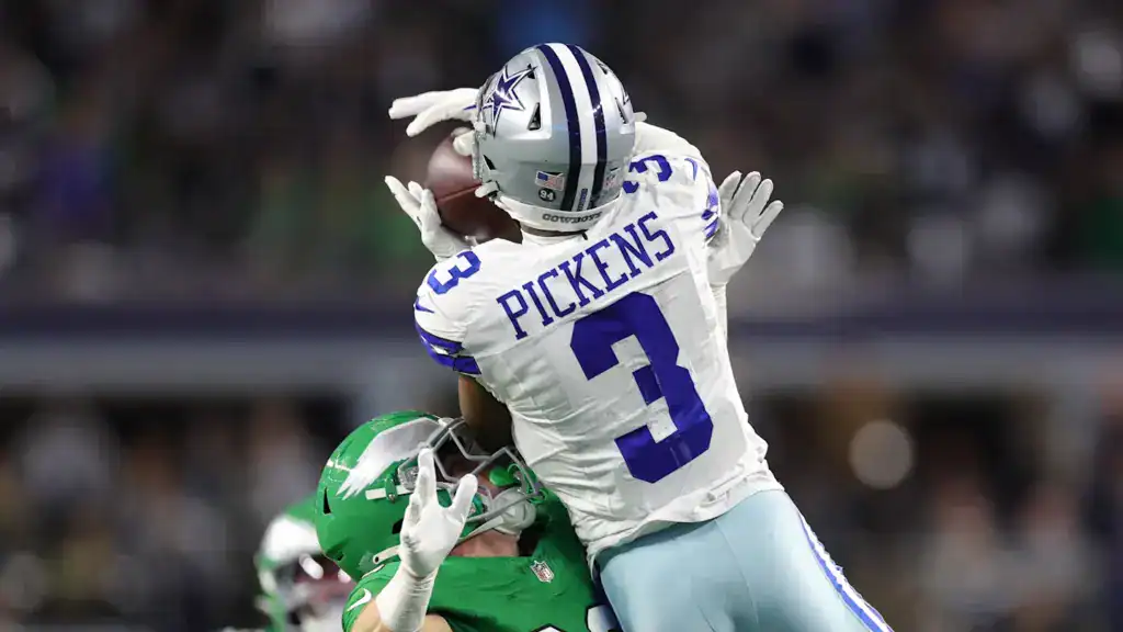 George Pickens contract extension alt text: George Pickens goes up for a contested catch in a Cowboys uniform against a defender, with his contract extension looming as one of Dallas’ biggest decisions.