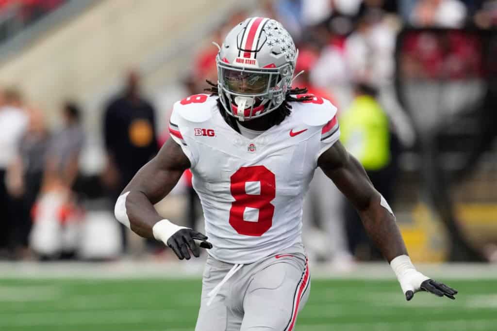 Arvell Reese of Ohio State in a white No. 8 uniform moving across the field during a college football game.
