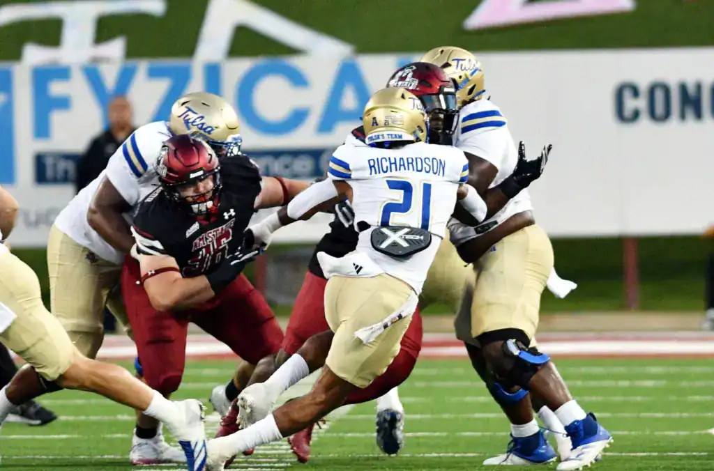 Running back Dominic Richardson dives toward the goal line in a night game, Cowboys undrafted free agent addition.