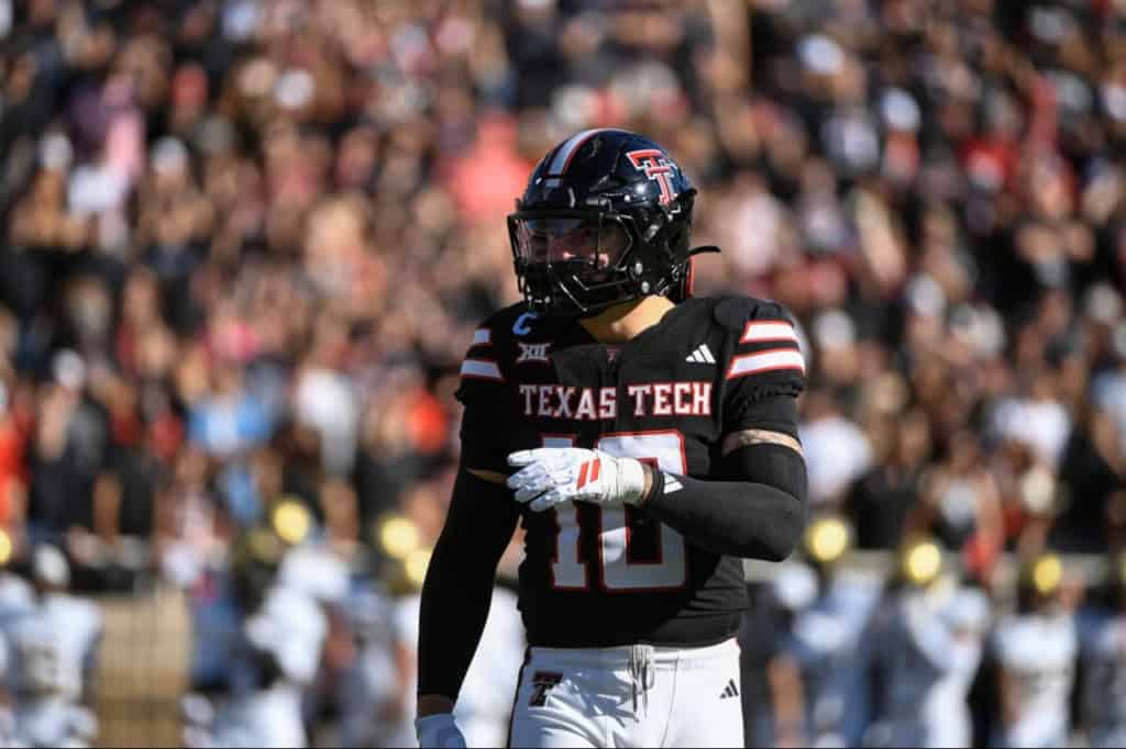 Jacob Rodriguez, Texas Tech linebacker and 2026 NFL Draft prospect, points across the field during a game in a black Red Raiders uniform.
