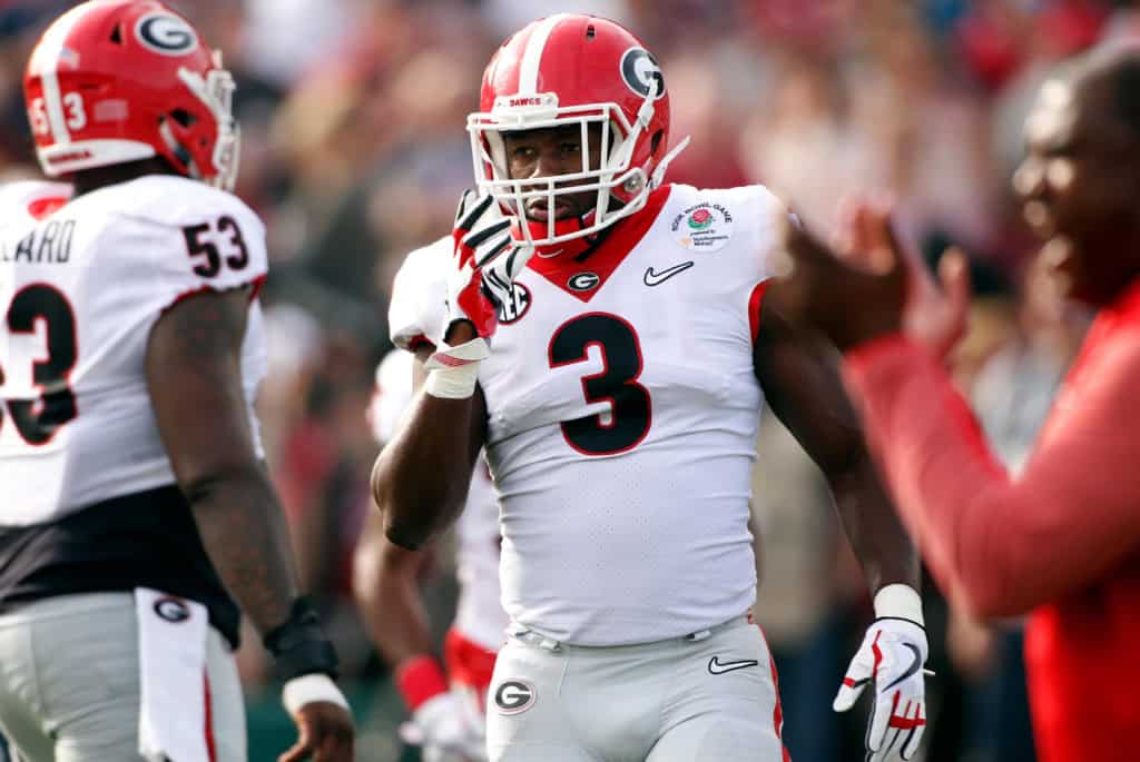 Georgia Bulldogs defender stands on the sideline during a bowl game, featuring university draft picks that earned First Team All-Pro status.