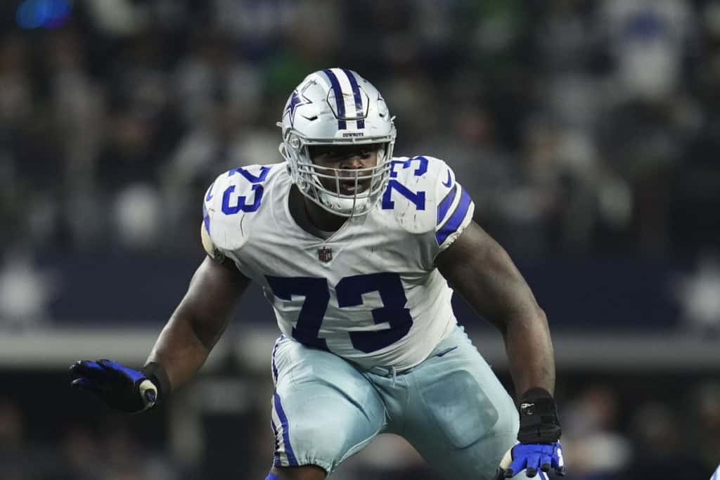 Dallas Cowboys offensive lineman Tyler Smith lined up on the field in his white Cowboys uniform, featured as part of the 2026 Offensive Depth Chart projection.