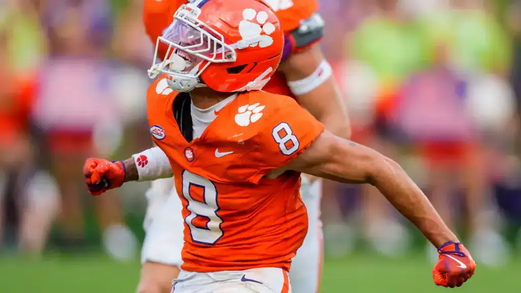 Avieon Terrell draft prospect celebrates for Clemson in an orange uniform, wearing No. 8 during a game.