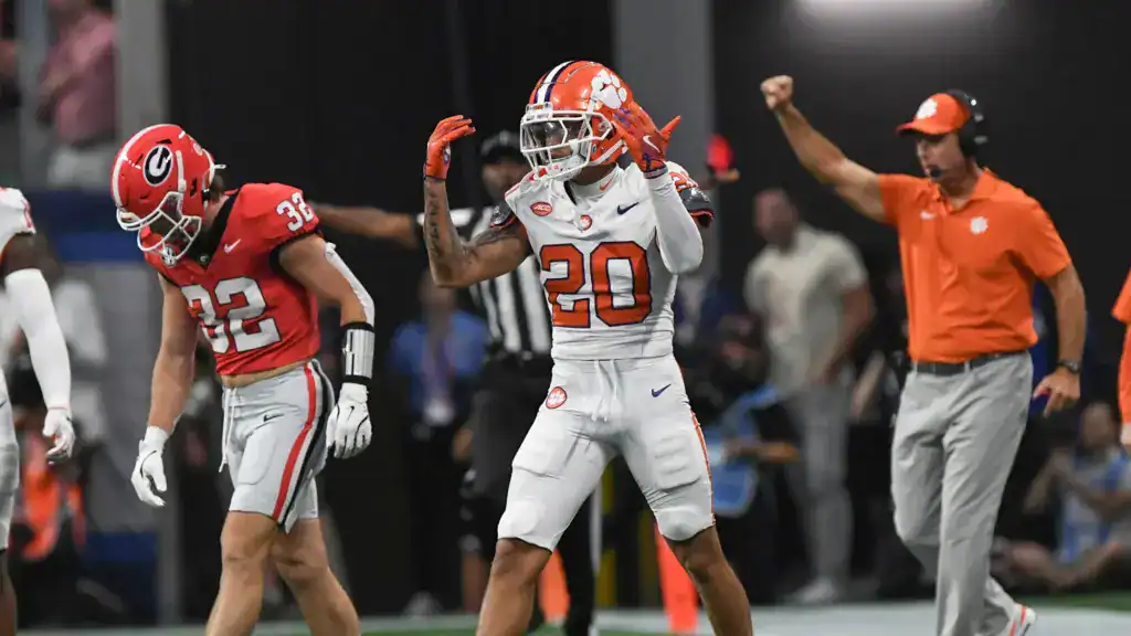 Avieon Terrell reacts after a strong defensive stop while Clemson coaches celebrate behind him.