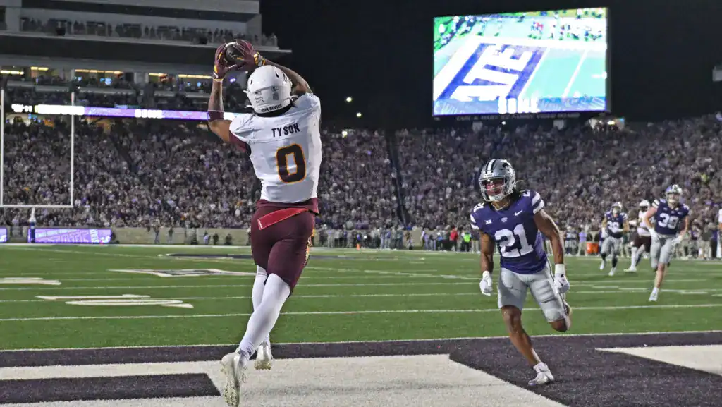 Jordyn Tyson catches a touchdown pass in the end zone for Arizona State as a Kansas State defender trails behind him.