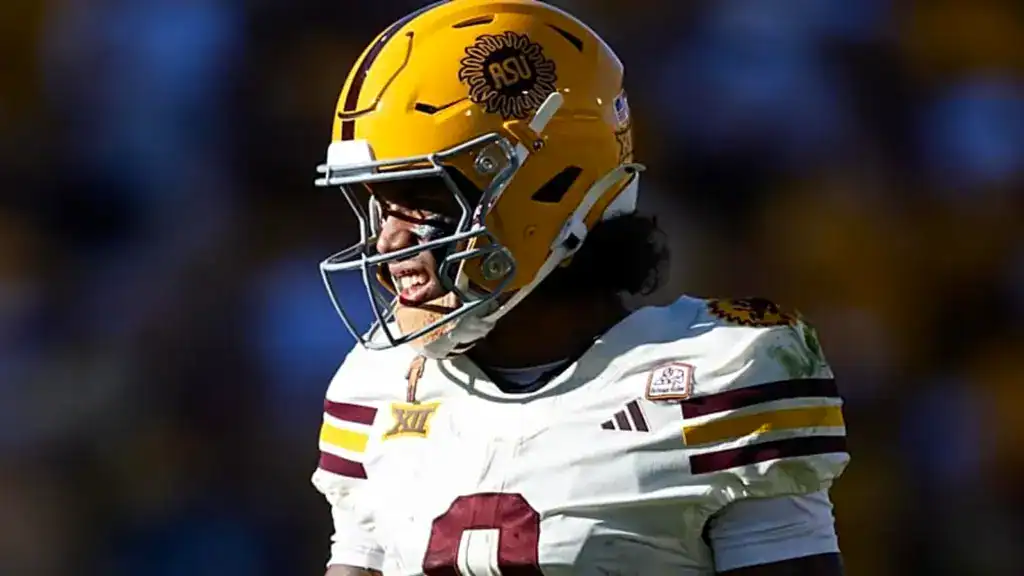 Jordyn Tyson draft prospect looks toward the sideline in Arizona State’s white uniform, wearing a gold helmet with the Sun Devils logo.