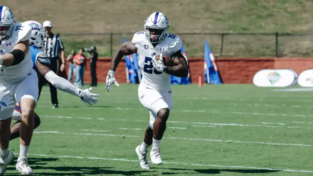 2026 NFL Draft sleeper Jordon Vaughn breaks into the open field for ACU, carrying the ball in a white uniform during a game.