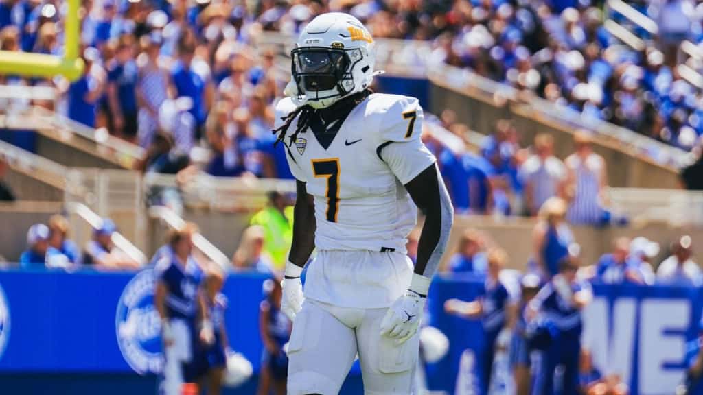 Emmanuel McNeil-Warren draft prospect walks the field for Toledo in an all-white uniform, wearing No. 7 with a dark visor.