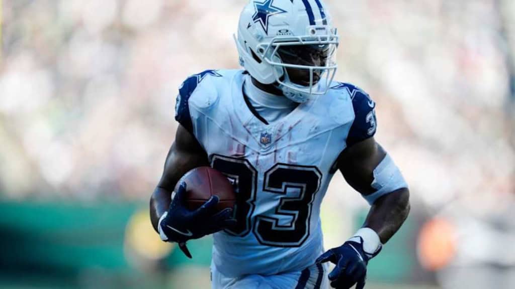 Dallas Cowboys running back Javonte Williams carrying the football in his white Cowboys uniform, featured as part of the 2026 Offensive Depth Chart projection.