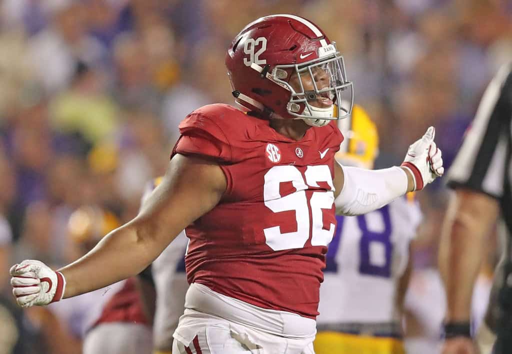 Alabama Crimson Tide defensive lineman celebrates during a game against LSU, spotlighting university draft picks that earned First Team All-Pro honors.