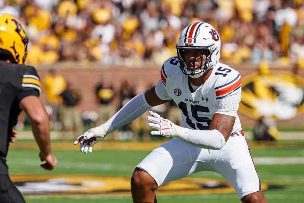 Auburn draft prospect Keldric Faulk squares up in coverage against Missouri, wearing No. 15 in a white Tigers road uniform.