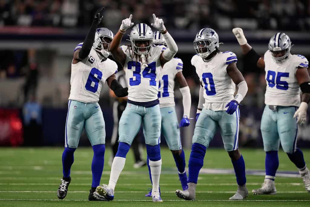 Shavon Revel Jr. celebrates with Dallas Cowboys teammates during a defensive stand at AT&T Stadium.