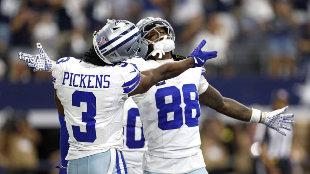 George Pickens and CeeDee Lamb celebrate in Dallas Cowboys uniforms during a game, representing the Cowboys in an NFC East betting odds.