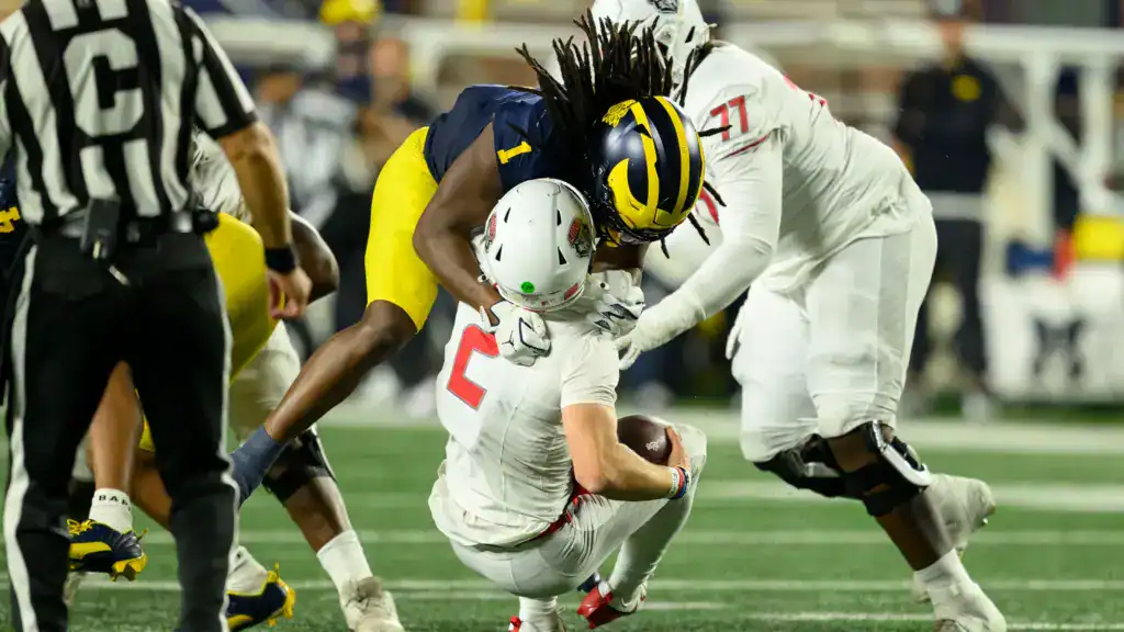 Jaishawn Barham sacks the quarterback while playing EDGE for Michigan before transitioning back to linebacker.