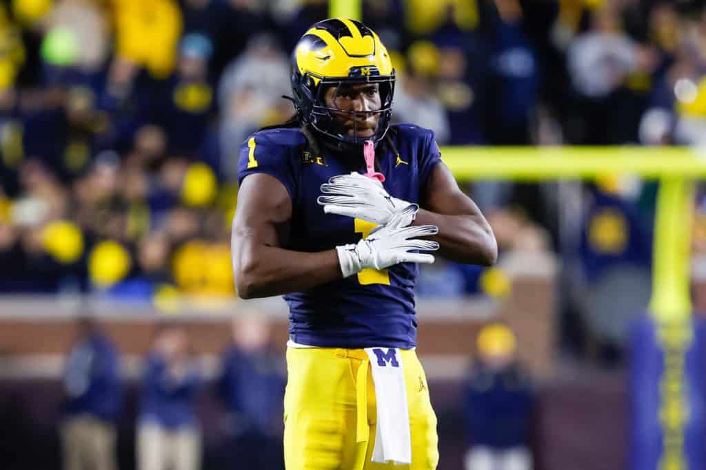 Jaishawn Barham stands on the field in his Michigan uniform during his college football career.