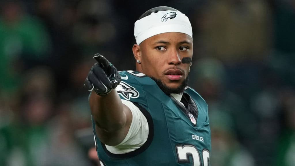 Saquon Barkley points during a Philadelphia Eagles game, representing the Eagles in an NFC East betting odds.
