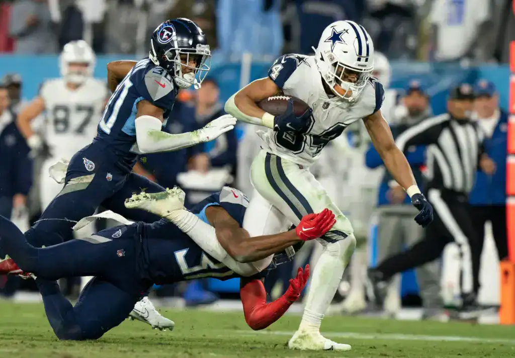 Malik Davis fights through contact against the Tennessee Titans during a Dallas Cowboys rushing attempt. 