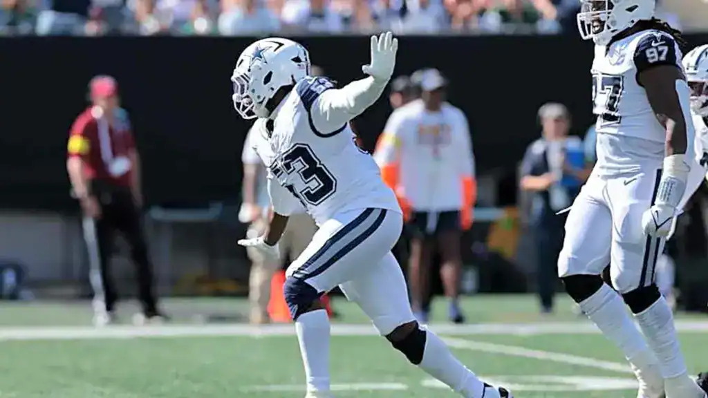 James Houston IV celebrating on the field in a Dallas Cowboys uniform. 