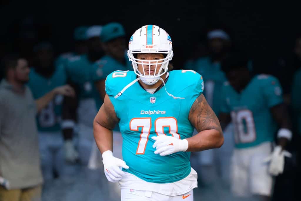 Veteran free agent offensive tackle Kendall Lamm runs onto the field in a Miami Dolphins uniform.