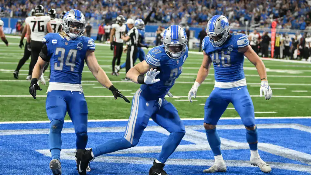 Detroit Lions defense celebrating in the end zone after a big play.