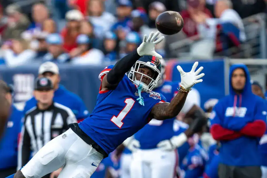 Malik Nabers reaches for a pass with the New York Giants as the NFC East wide receiver debate heats up entering 2026.