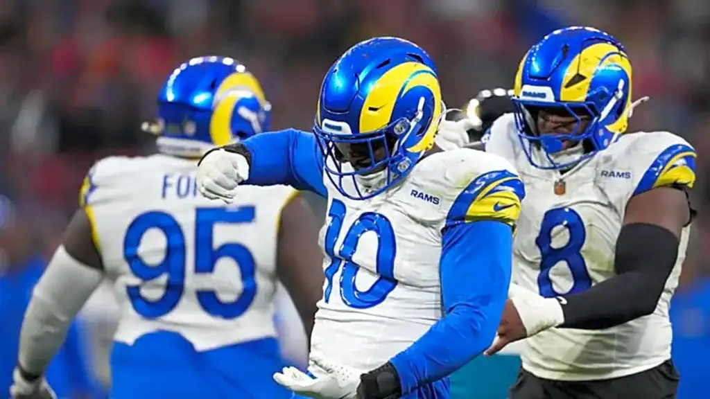 Los Angeles Rams defense celebrating together after a defensive play.
