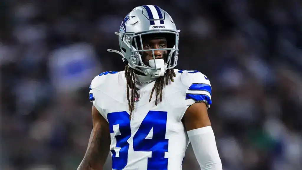 Shavon Revel Jr. looks on from the field in his Dallas Cowboys No. 34 uniform.