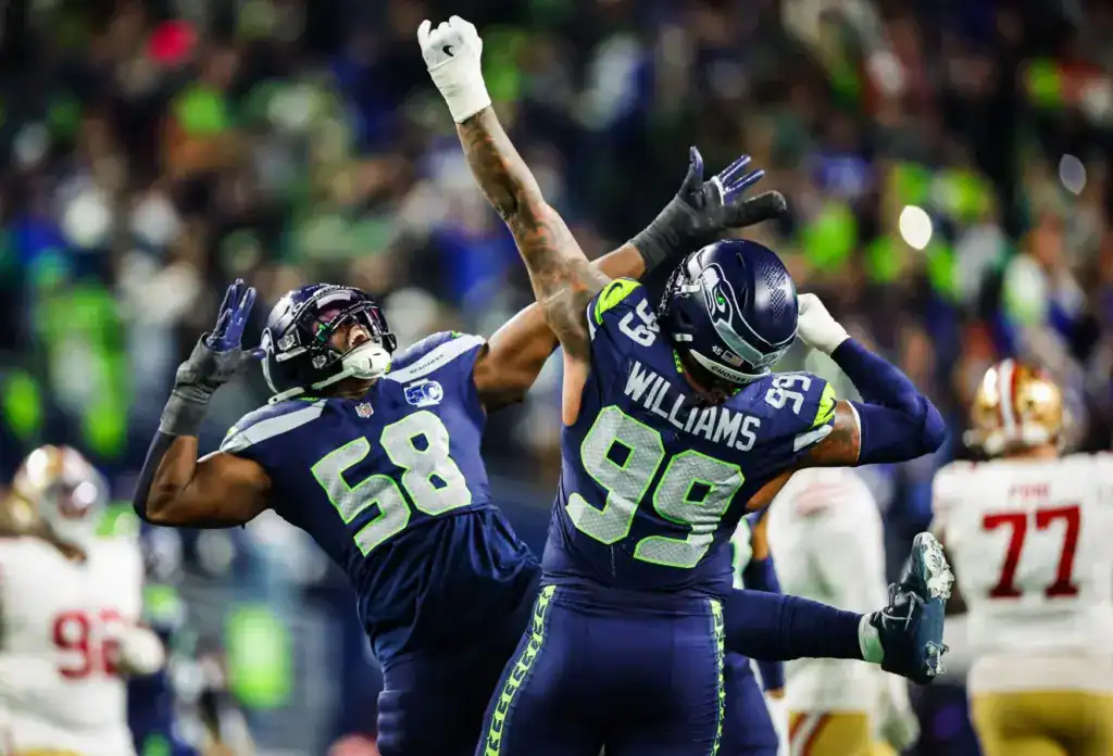 Seattle Seahawks defense celebrating after a pass breakup against the 49ers.