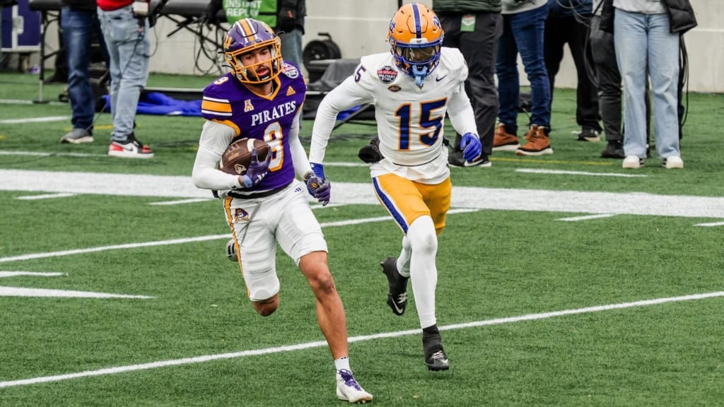 Anthony Smith runs up the sideline with the football for East Carolina as a defender chases him from behind.