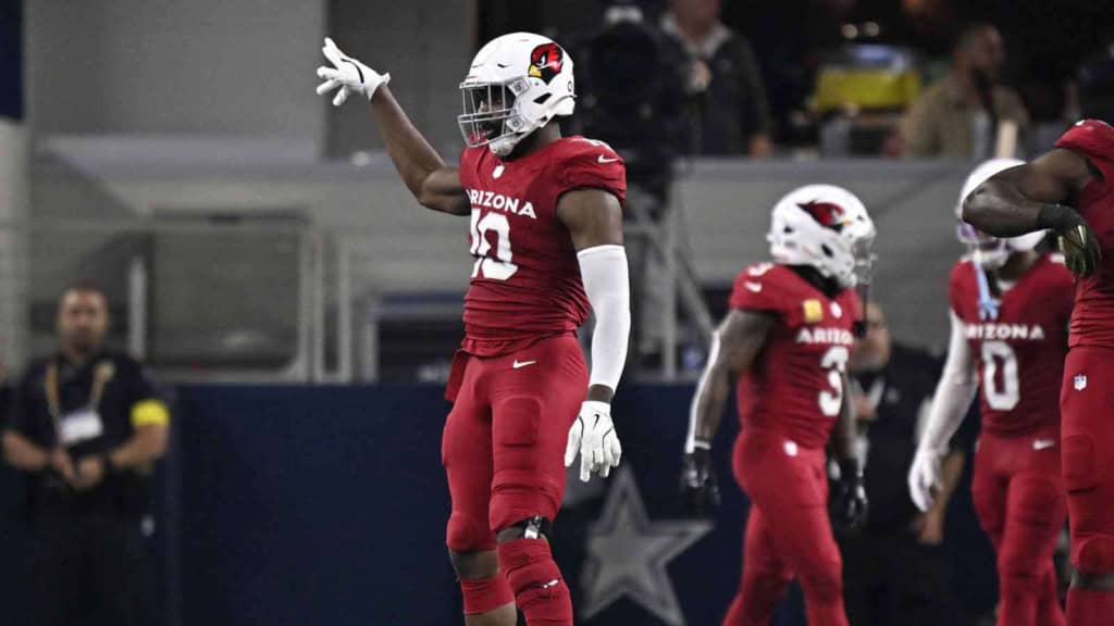 Josh Sweat gestures to teammates during an Arizona Cardinals defensive series.
