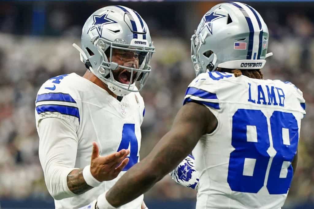 Dak Prescott talks with CeeDee Lamb as the Dallas Cowboys look to clean up mistakes and improve offensive execution.
