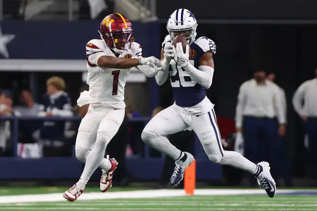 DaRon Bland intercepts a pass against Washington Commanders wide receiver Jahan Dotson.