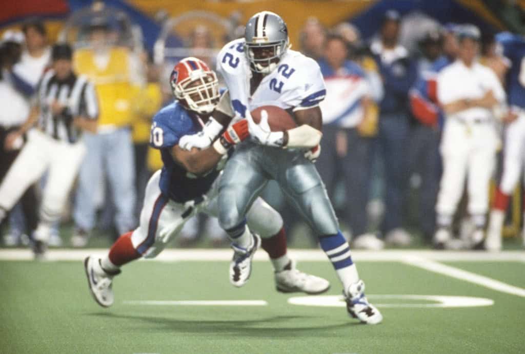 Building the Greatest Cowboys Offense Ever: Legends, Locks, and Tough Calls Emmitt Smith carries the football for the Dallas Cowboys as the franchise’s all-time rushing king