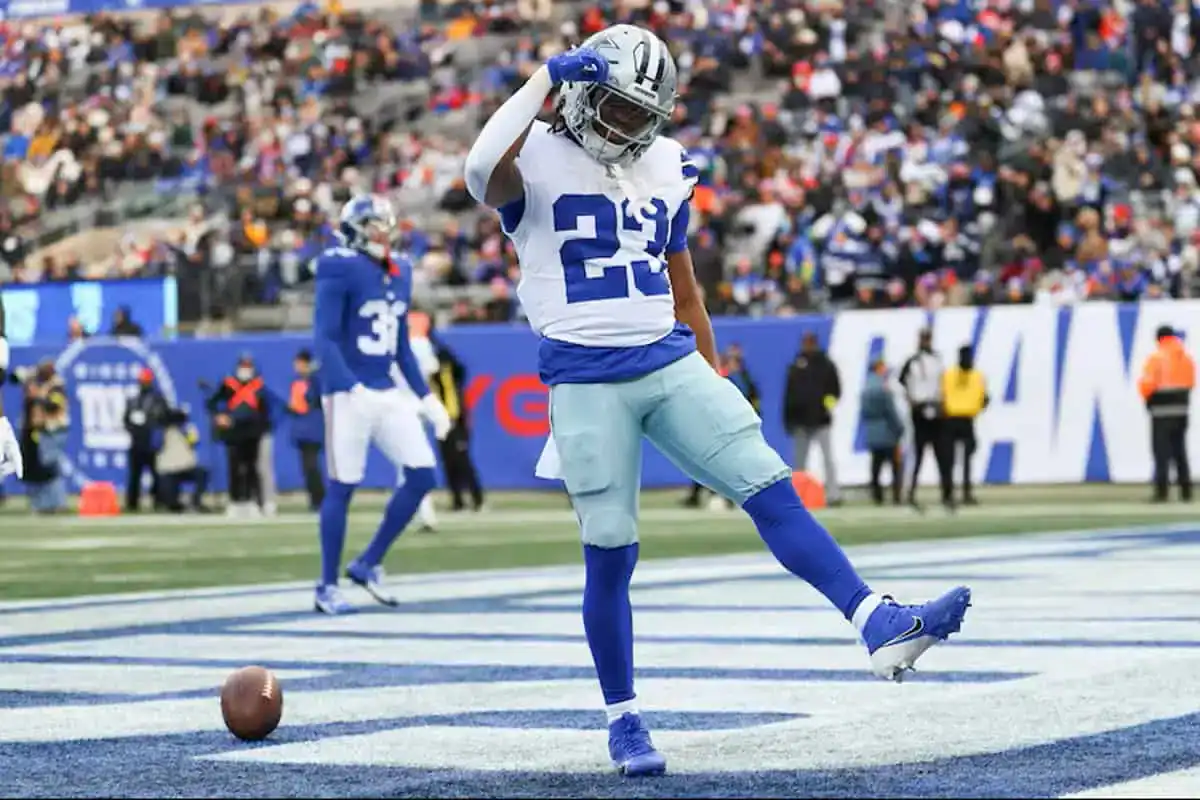 Jaydon Blue celebrates in the end zone for the Dallas Cowboys after scoring a touchdown