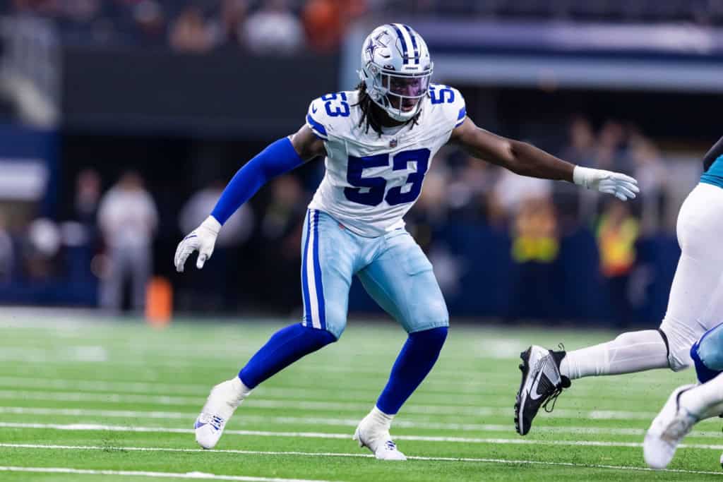 Isaiah Land rushing off the edge for the Dallas Cowboys during game action.