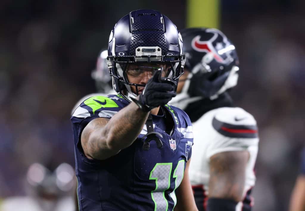 Jaxon Smith-Njigba points during a Seattle Seahawks game as rising wide receiver contracts reshape George Pickens’ 2026 market.