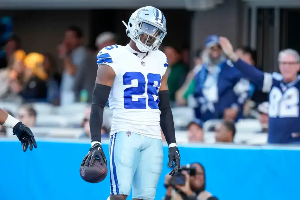 DaRon Bland walks off the field holding the football after another Dallas Cowboys takeaway.
