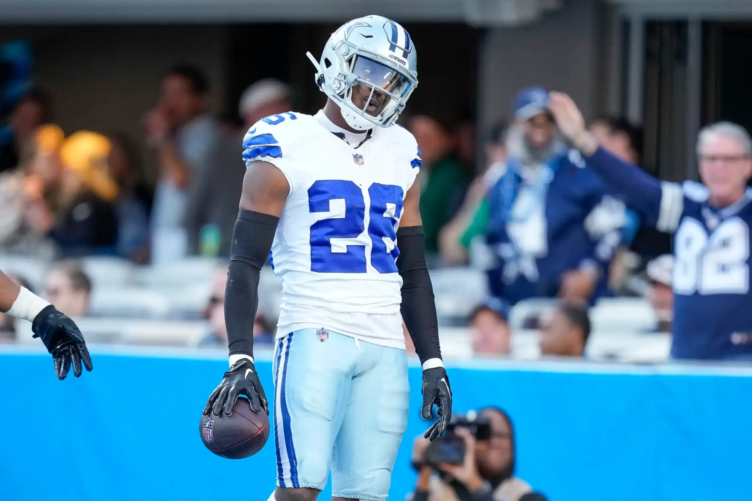 DaRon Bland walks off the field holding the football after another Dallas Cowboys takeaway.