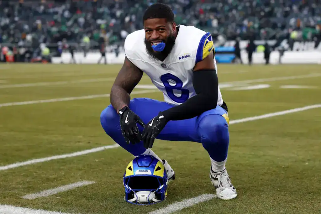 Jared Verse kneels on the field in his Los Angeles Rams uniform as the Rams’ defensive front raises the pressure on the 2026 Cowboys.