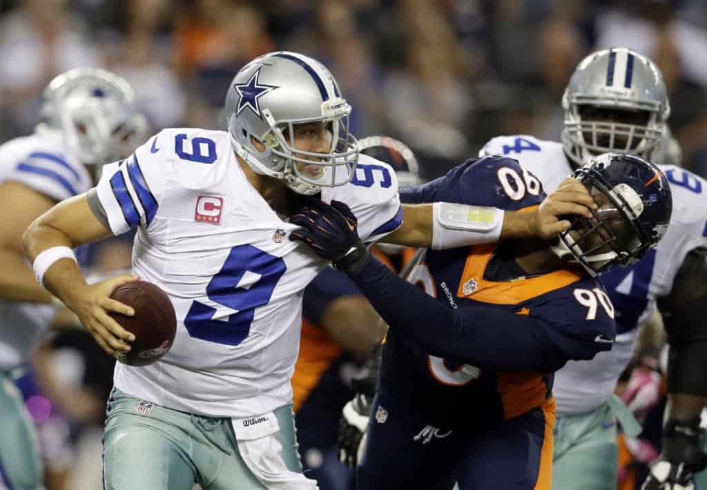 Tony Romo fighting through pressure against the Broncos, proving PFF’s Cowboys offense list got too cute.