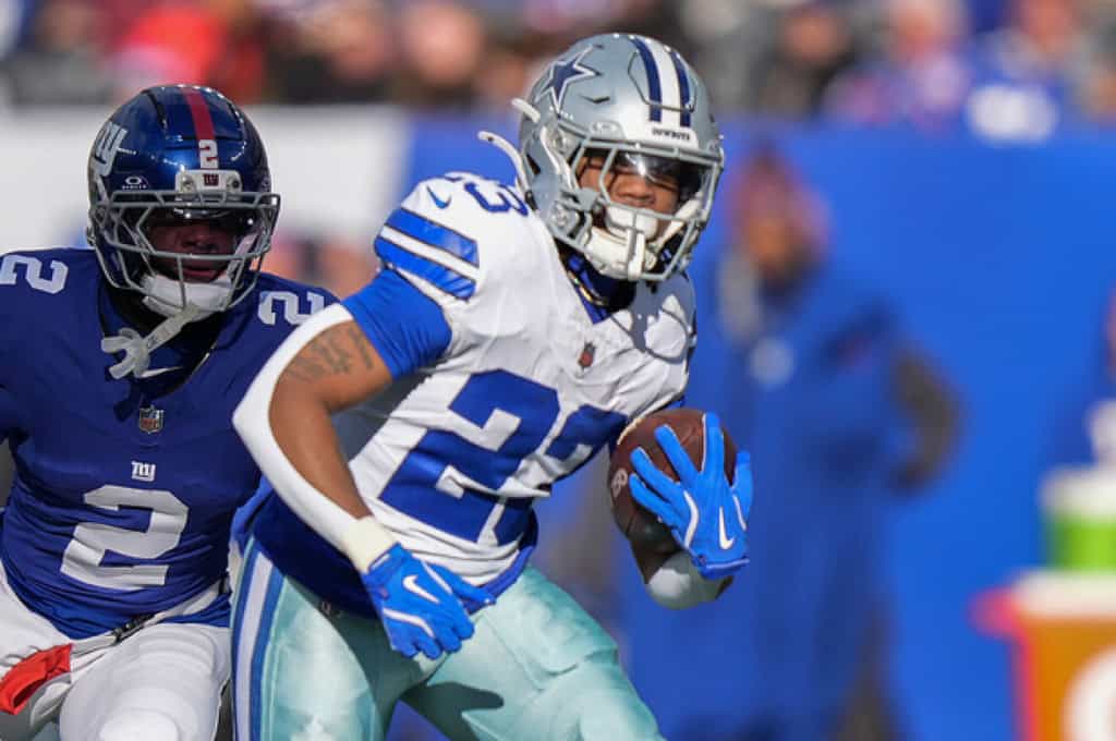 Jaydon Blue carries the football for the Dallas Cowboys against the New York Giants.