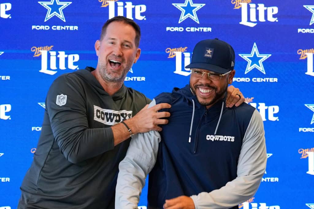 Christian Parker's Hire Follows a Cowboys Super Bowl Pattern Dallas Cowboys defensive coordinator Christian Parker and head coach Brian Schottenheimer smiling and laughing at Parker's introductory press conference.